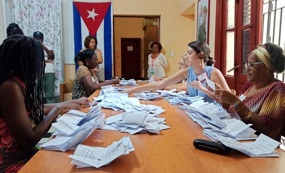 epa10544798 Poll workers carry out the vote count at a polling station at the close of electoral day in Havana, Cuba, 26 March 2023. Polling stations in Cuba closed their doors at 7:00 p.m. local time ...