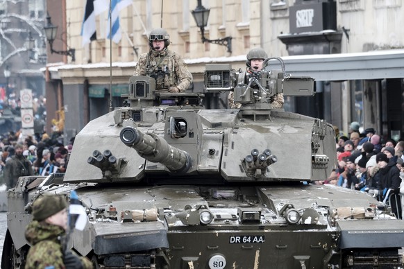 epa10488408 British soldiers of eFP Battlegroup in Estonia with their battle tank Challenger attend the Defence Forces parade during the 105th Independence Day celebration in Tallinn, Estonia, 24 Febr ...