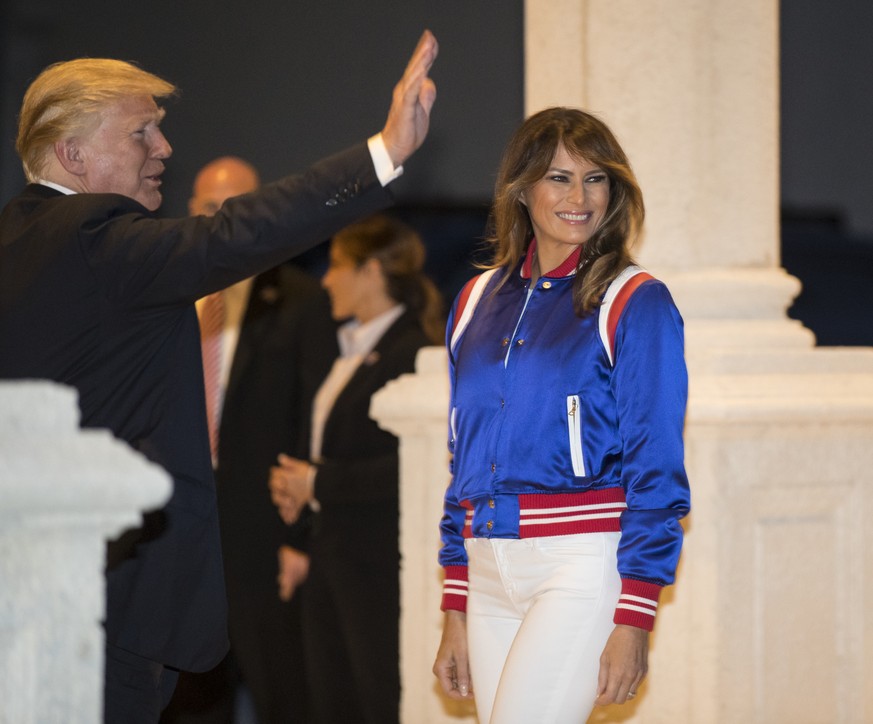 President Donald Trump and first lady Melania turn to go inside after viewing the Florida Atlantic University Marching Band at Trump International Golf Club in West Palm Beach, Fla., Sunday, Feb. 4, 2 ...