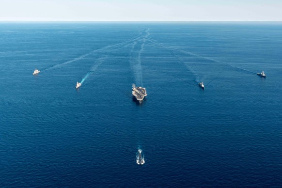 epa10215018 A handout photo made available by the South Korean Defense Ministry shows the USS Annapolis (front), the nuclear-powered aircraft carrier USS Ronald Reagan (C), and Japanese Asahi-class de ...