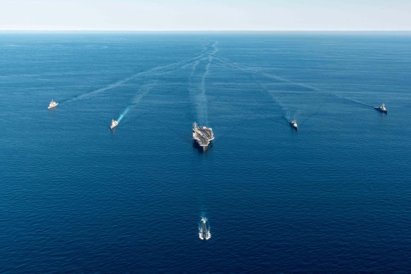 epa10215018 A handout photo made available by the South Korean Defense Ministry shows the USS Annapolis (front), the nuclear-powered aircraft carrier USS Ronald Reagan (C), and Japanese Asahi-class de ...