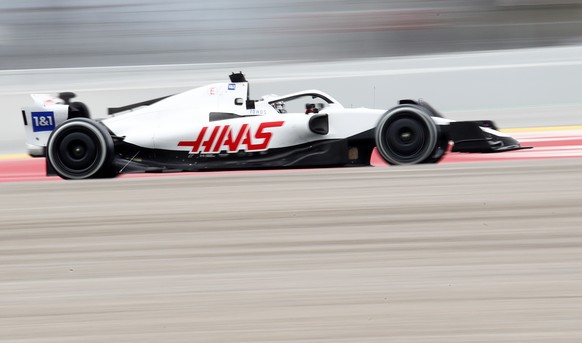 Hass driver Nikita Mazepin steers his car during a Formula One pre-season testing session at the Catalunya racetrack in Montmelo, just outside of Barcelona, Spain, Friday, Feb. 25, 2022. (AP Photo/Joa ...