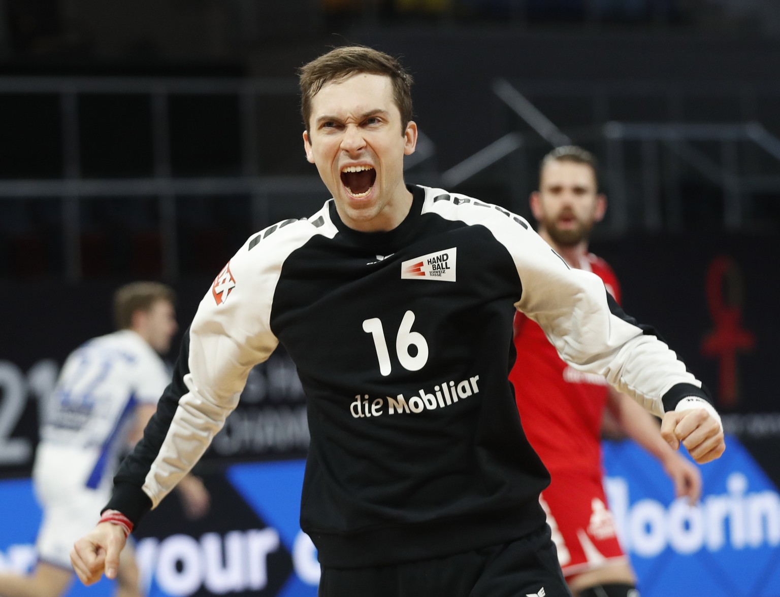 Switzerland&#039;s goal keeper, Nikola Portner, celebrates after saving a ball during the World Handball Championship between Switzerland and Iceland, in Cairo, Egypt, Wednesday, Jan. 20, 2021. (AP Ph ...