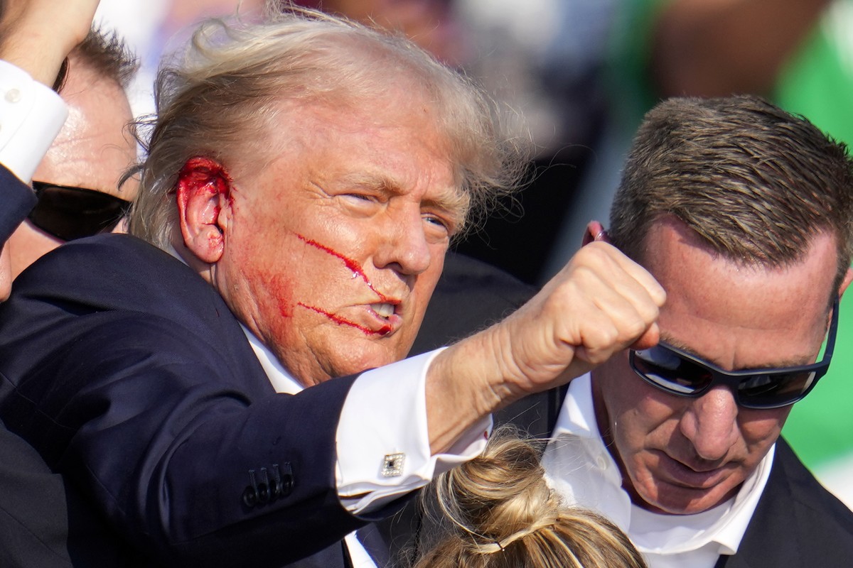Republican presidential candidate former President Donald Trump reacts following an assassination attempt at a campaign event in Butler, Pa., on Saturday, July 13, 2024. (AP Photo/Gene J. Puskar)
Elec ...