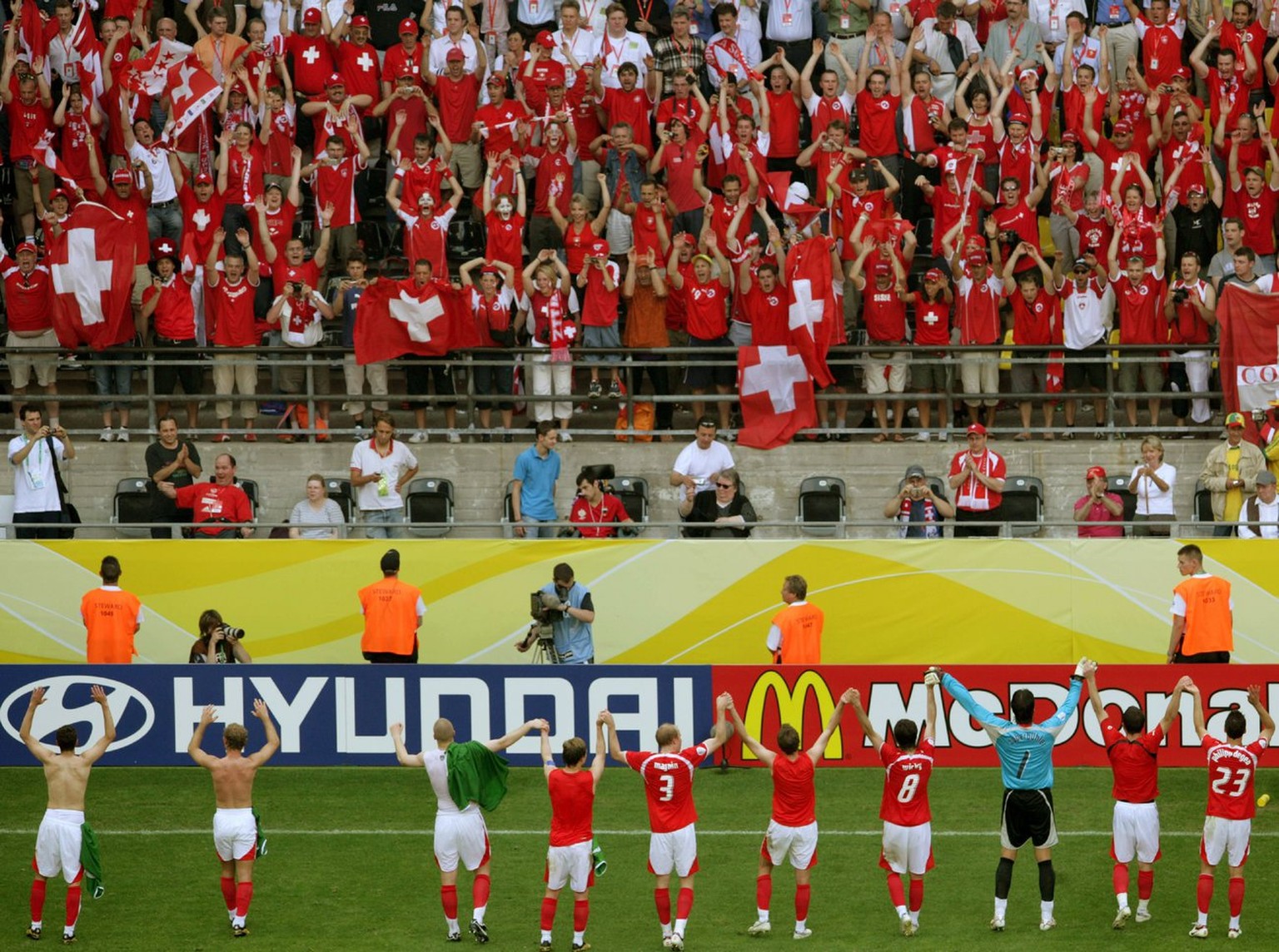 The players of the Swiss team celebrate with the fans after defeating Togo in the 2006 FIFA World Cup group G match of Togo vs Switzerland in Dortmund , Germany, Monday, 19 June, 2006. Switzerland won ...