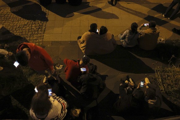 Supporters of Republican People&#039;s Party use their cellphones to watch the election results outside the headquarters of CHP, in Ankara, Turkey, Sunday, May 14, 2023. More than 64 million people, i ...