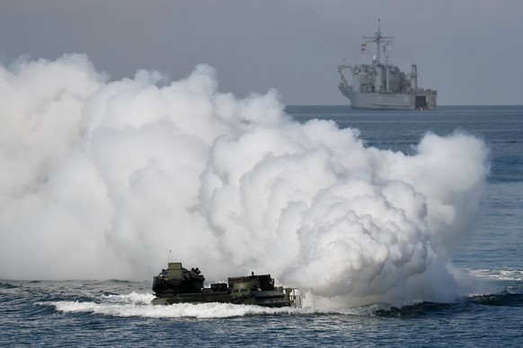 epa10094829 Taiwan&#039;s AAV7 amphibious assault vehicle maneuvers across the sea in front of a Newport-class tank landing ship during Amphibious landing drill as part of the Han Kuang military exerc ...