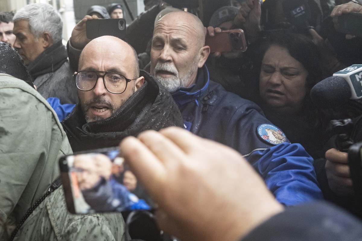 The owner of "Le Constellation" bar in Crans-Montana, Jacques Moretti of France, left, is screamed at by a mother of a victim, right, ahead of the hearing before the public prosecutor of the ...