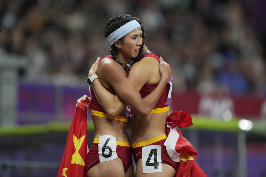 Gold medalist China&#039;s Lin Yuwei, left, hugs compatriot and silver medalist China&#039;s Wu Yanni after their women&#039;s 100-meter hurdles final at the 19th Asian Games in Hangzhou, China, Sunda ...