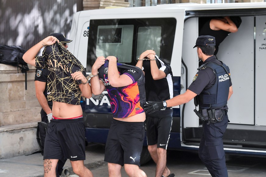epa10747422 Spanish policemen escort six German tourists arrested for allegedly sexually assaulting a German young woman upon arrival to the courts of Palma de Mallorca, Mallorca Island, Balearics, Sp ...
