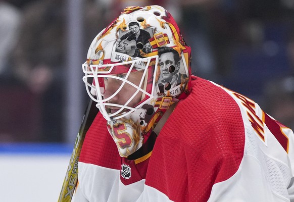 FILE - Artwork of Johnny Cash adorns the mask of Calgary Flames goalie Jacob Markstrom as he watches the action during the second period of an NHL hockey game against the Vancouver Canucks in Vancouve ...