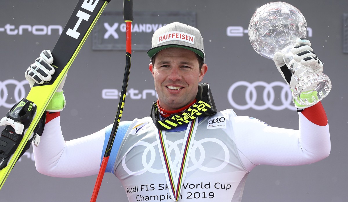 Switzerland's Beat Feuz celebrates holding the men's World Cup downhill discipline trophy, at the alpine ski World Cup finals, in Soldeu, Andorra, Wednesday, March 13, 2019. (AP Photo/Alessa ...