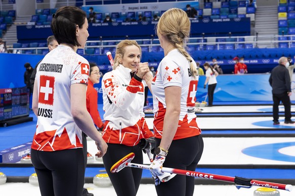Switzerland skip Silvana Tirinzoni, center, greets her teammates Esther Neuenschwander, left, and Melanie Barbezat, right, after defeating the China team, during the women&#039;s Round Robin #2 game b ...