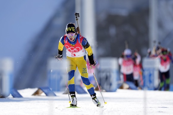 Linn Persson of Sweden skis onto the shooting range during the women&#039;s 4x6-kilometer relay at the 2022 Winter Olympics, Wednesday, Feb. 16, 2022, in Zhangjiakou, China. (AP Photo/Frank Augstein)