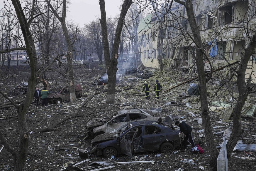 Ukrainian emergency employees work at a maternity hospital damaged by shelling in Mariupol, Ukraine, Wednesday, March 9, 2022. (AP Photo/Evgeniy Maloletka)