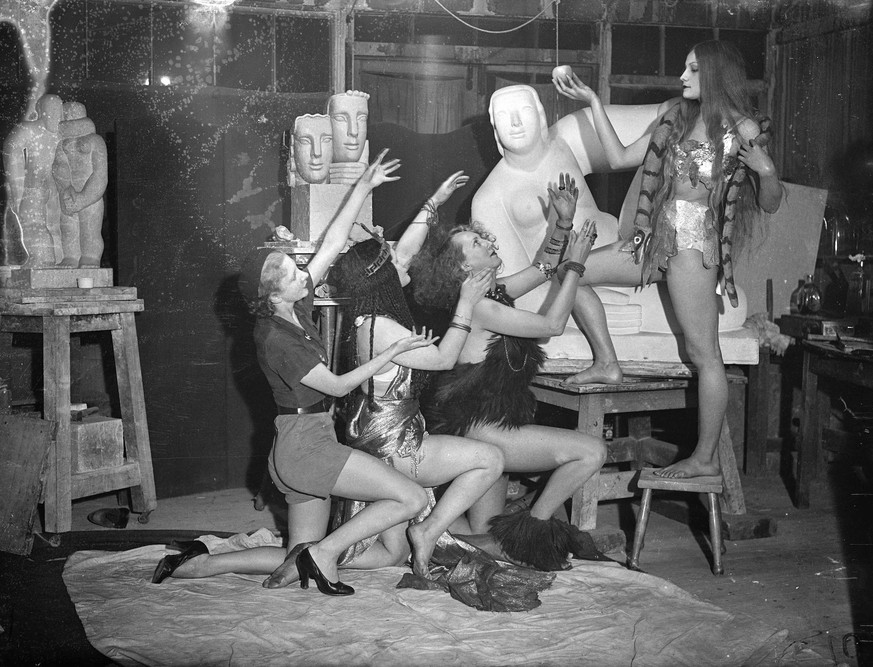The cave girl . Students are preparing for the Chelsea Arts Ball , the theme of which is Looking backwards to be held at the Royal Albert Hall on New Year s Eve . Photo shows , reaching for the apple  ...