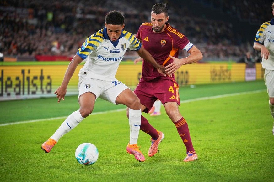 Roma's Bryan Cristante, right, vies the ball from Parma's Sascha Britschgi during a Serie A soccer match between Roma and Parma, in Rome, Italy, on Wednesday, Oct. 29, 2025. (AP Photo/Andrew ...