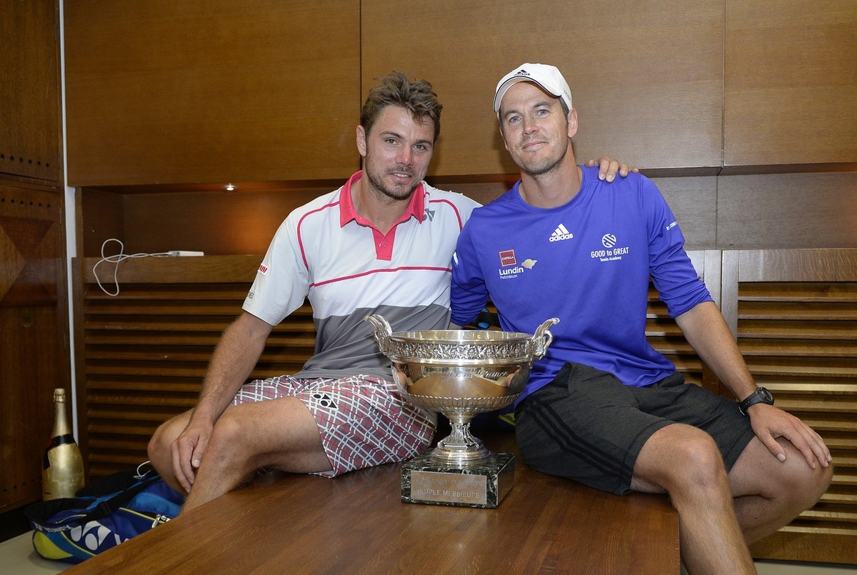 Switzerland's Stan Wawrinka, left, poses with his coach Magnus Norman, of Sweden, and the cup in the cloakroom of the stadium after winning the French Open tennis tournament against Serbia's ...