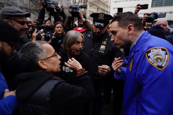 epa10558203 New York City Police (NYPD) officers attempt to segregate pro- and anti-Trump protesters outside the New York Criminal Court in New York, New York, U.S. April 04, 2023. A Manhattan grand juror...