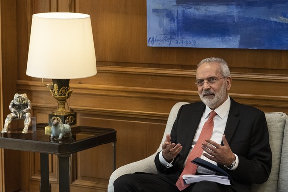 Greek Caretaker Prime Minister Ioannis Sarmas, speaks with outgoing Prime Minister Kyriakos Mitsotakis during a handover ceremony at Maximos mansion, in Athens, Thursday, May 25, 2023. (AP Photo/Petro ...