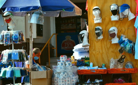 epa08428733 A person sells face masks and hygiene supplies, during the COVID-19 crisis, in Mexico City, Mexico, 17 May 2020. EPA/Jorge Nunez