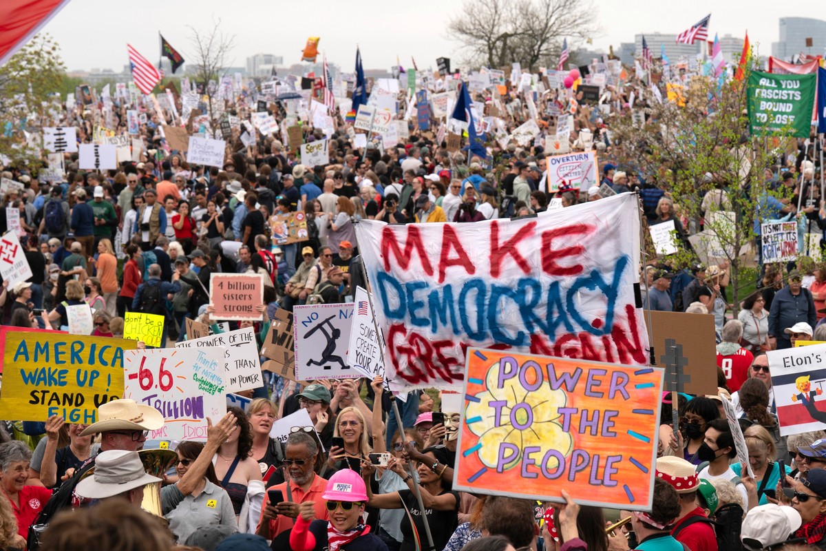 Demonstrators hold up signs during a "Hands Off!" protest against President Donald Trump at the Washington Monument in Washington, Saturday, April 5, 2025. (AP Photo/Jose Luis Magana)
Trump  ...