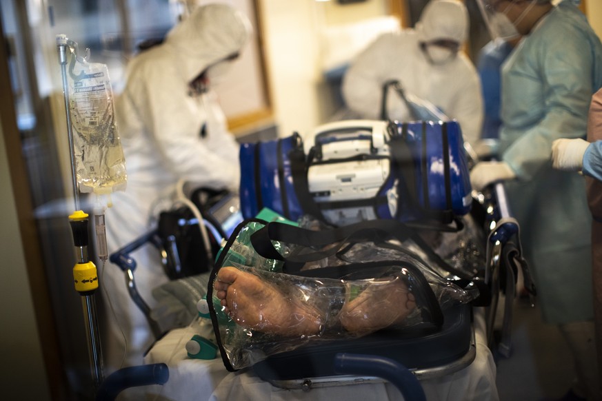 Medical personnel, wearing protective equipment, work with a coronavirus patient prior to transfer by helicopter from the COVID-19 intensive care unit of the CHU Liege hospital to another hospital in  ...