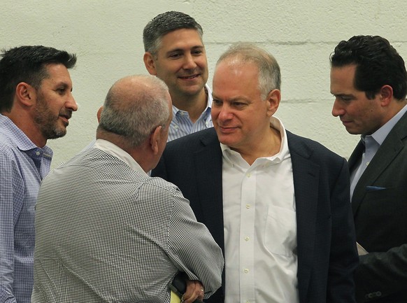 In this Dec. 20, 2016 photo, Stephen Bittel, center, chats with voters as members of the Miami-Dade Democratic Party Executive Committee meet in Wynwood, Fla., to elect a new state committeeman. Flori ...