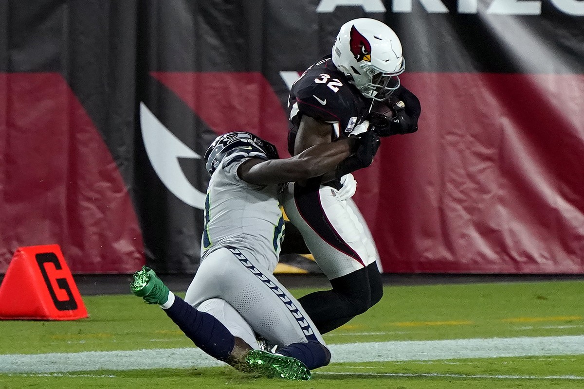 Seattle Seahawks wide receiver DK Metcalf tackles Arizona Cardinals strong safety Budda Baker (32) short of the goal line after Baker intercepted a pass during the first half of an NFL football game,  ...