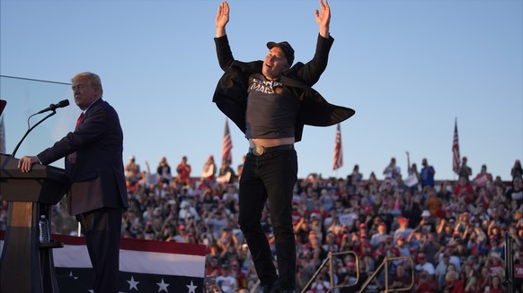 Elon Musk jumps on the stage as Republican presidential nominee former President Donald Trump speaks at a campaign rally at the Butler Farm Show, Saturday, Oct. 5, 2024, in Butler, Pa. (AP Photo/Evan  ...