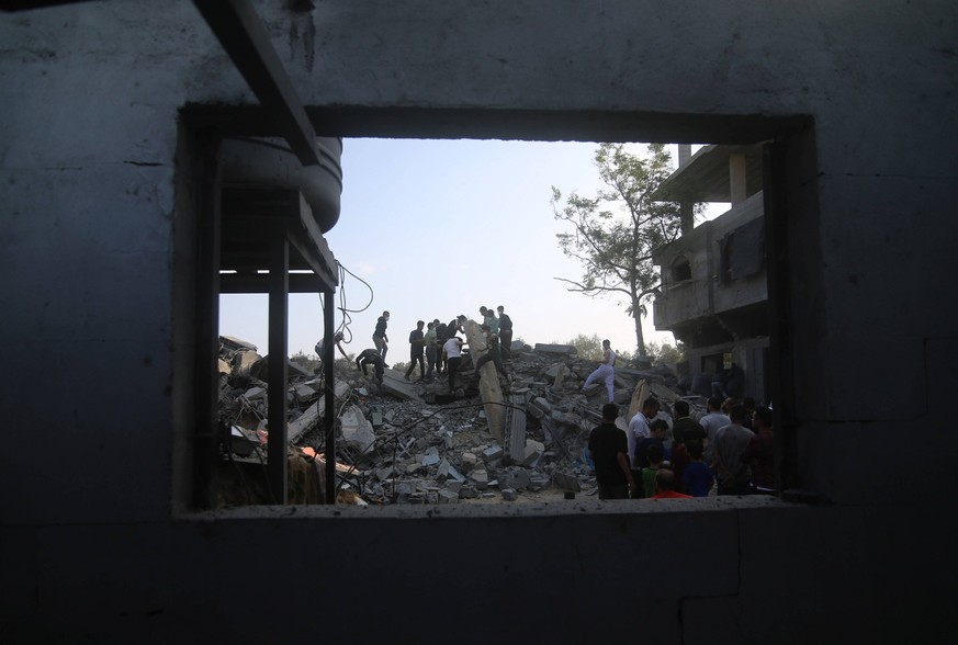 231014 -- GAZA, Oct. 14, 2023 -- People inspect buildings destroyed in Israeli airstrikes in the southern Gaza Strip city of Rafah, Oct. 14, 2023. The ongoing conflict between Gaza-ruling Palestinian  ...