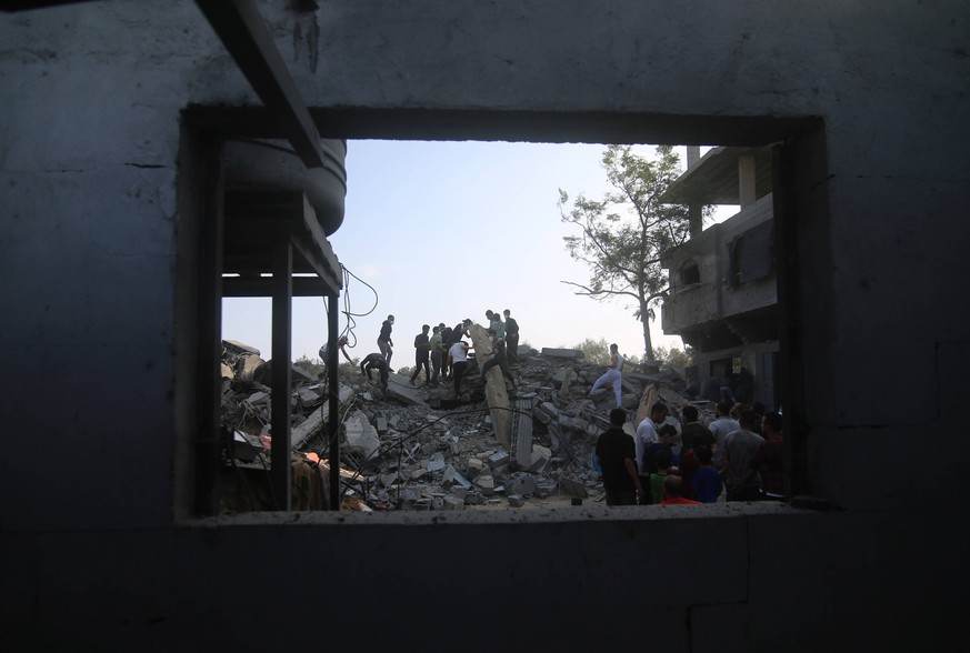 231014 -- GAZA, Oct. 14, 2023 -- People inspect buildings destroyed in Israeli airstrikes in the southern Gaza Strip city of Rafah, Oct. 14, 2023. The ongoing conflict between Gaza-ruling Palestinian ...
