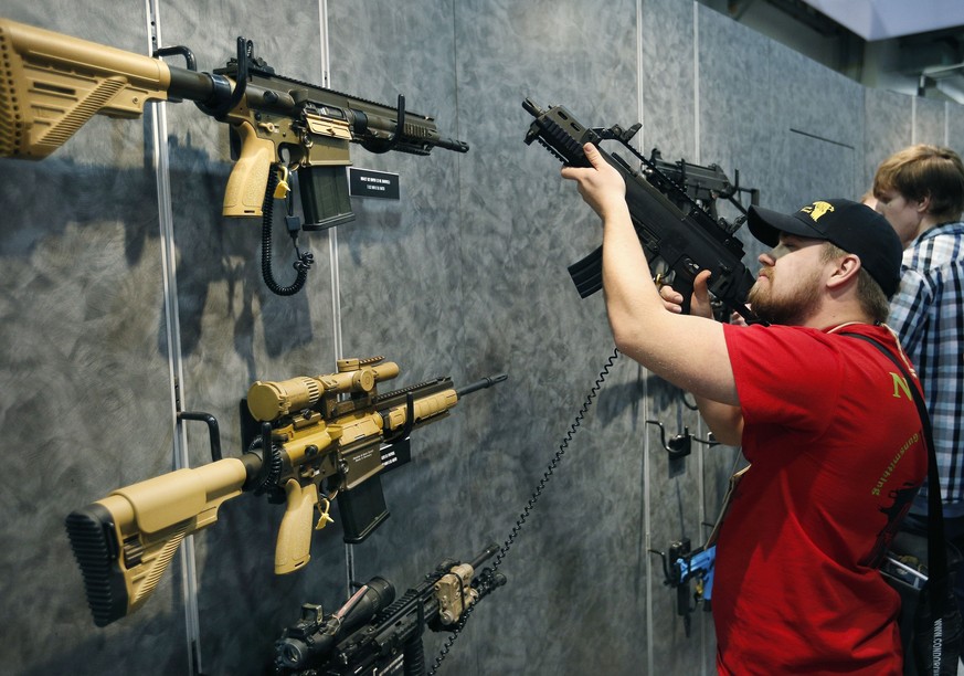 FILE - In this Jan. 19, 2016 file photo, Nolan Hammer looks at a gun at the Heckler &amp; Koch booth at the Shooting, Hunting and Outdoor Trade Show in Las Vegas. Backers of an expanded gun background ...