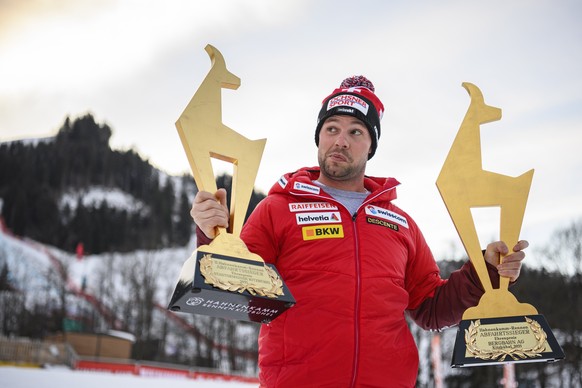 epa08962491 Beat Feuz of Switzerland poses for photographs with his Gams trophies after winning the two men&#039;s Downhill races of the FIS Alpine Skiing World Cup event in Kitzbuehel, Austria, 24 Ja ...