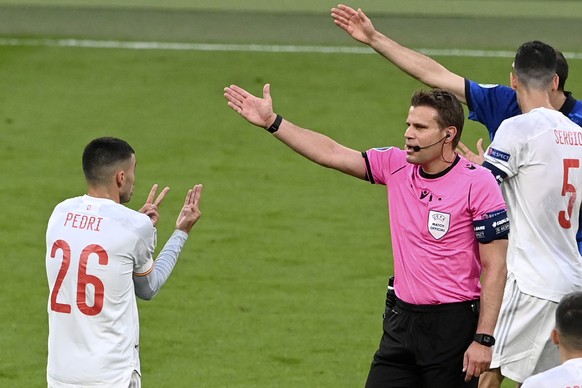 Referee Felix Brych gestures to Spain's Pedri, left, during the Euro 2020 soccer championship semifinal match between Italy and Spain at Wembley stadium in London, Tuesday, July 6, 2021. (Facundo ...