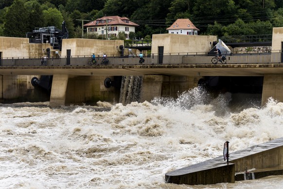 Water flows through the Hagneck dam between the Aare and the Bielersee in Hagneck, Switzerland, Friday, July 16, 2021. The water level of the Bielersee continued to rise throughout the night, exceedin ...