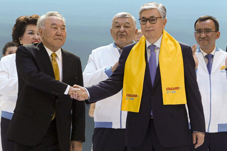 FILE Kazakhstan&#039;s acting President Kassym-Jomart Tokayev, right, and Former Kazakh President Nursultan Nazarbayev shake hands in front of their supporters in Nur-Sultan, the capital city of Kazak ...