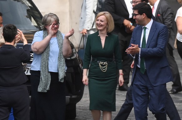 epa10082425 Conservative party leadership candidate Liz Truss (C) is applauded by fellow members of the parliament after winning the backing to be one of the two final nominees at the Houses of Parlia ...