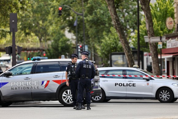 260727 -- PARIS, July 27, 2026 -- Policemen and police vehicles are seen near the site of a knife attack in Paris, France, July 27, 2026. Three people were injured in a knife attack in Paris on Monday ...