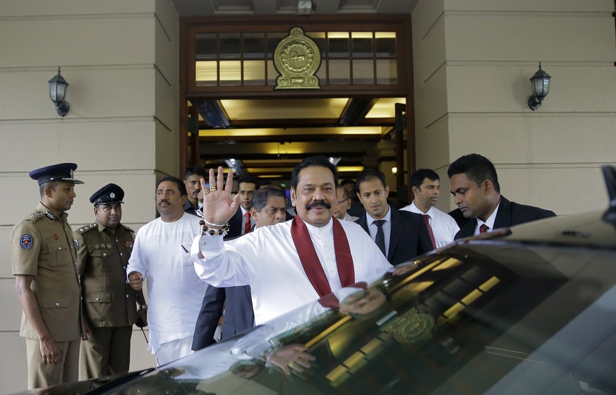 Sri Lankan prime minister Mahinda Rajapaksa waves to people after assuming duties as finance minister in Colombo, Sri Lanka, Wednesday, Oct. 31, 2018. President Maithripala Sirisena dismissed Ranil Wi ...