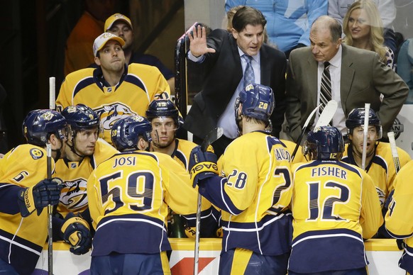 Nashville Predators head coach Peter Laviolette, top center, talks to his players during a timeout in the third period of an NHL hockey game against the New York Rangers Saturday, Feb. 7, 2015, in Nas ...