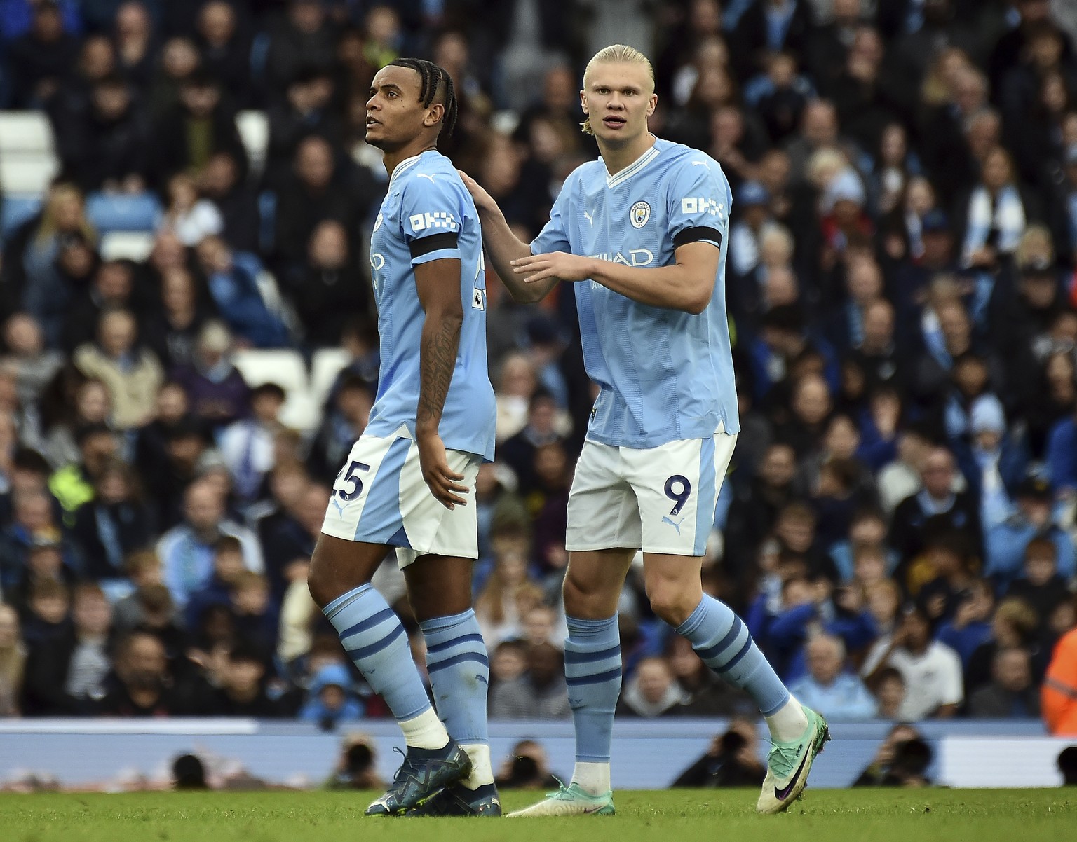 Manchester City&#039;s Manuel Akanji, left, is consoled by teammate Erling Haaland after receiving a red card during the English Premier League soccer match between Manchester City and Brighton &amp;  ...