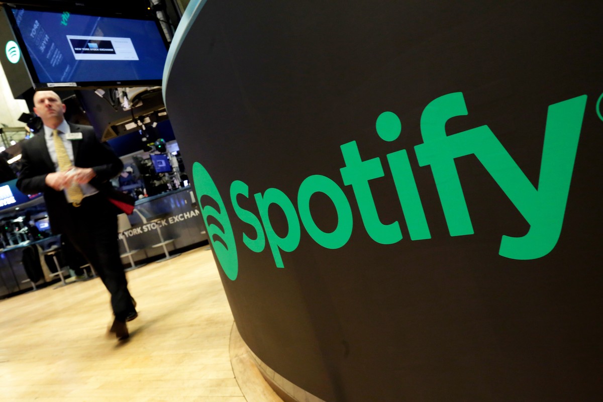 FILE - A trading post sports the Spotify logo on the floor of the New York Stock Exchange, Tuesday, April 3, 2018. Spotify said Monday, Dec. 4, 2023 it's axing 17% of its global workforce, in the ...
