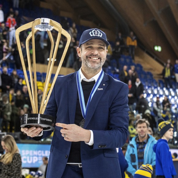 Davos&#039; Head Coach Josh Holden celebrates with the trophy after the final game between Switzerland&#039;s HC Davos and HC Dynamo Pardubice from Czech Republic, at the 95th Spengler Cup ice hockey  ...