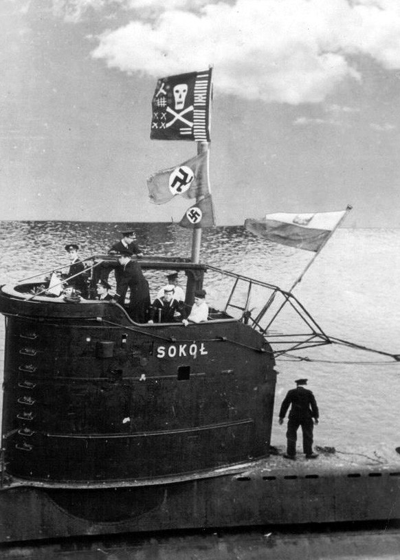 The Polish submarine ORP Sokół returning to base in 1944. A Jolly Roger flag and two captured Nazi flags are flying from the periscope mast. 
The Polish submarine ORP Sokół returning to base in 1944.  ...