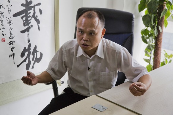 In this photo taken Thursday, July 23, 2015, Chinese lawyer Yu Wensheng speaks during an interview at his office in Beijing. Yu who spoke up on behalf of rights lawyers persecuted by authorities was h ...