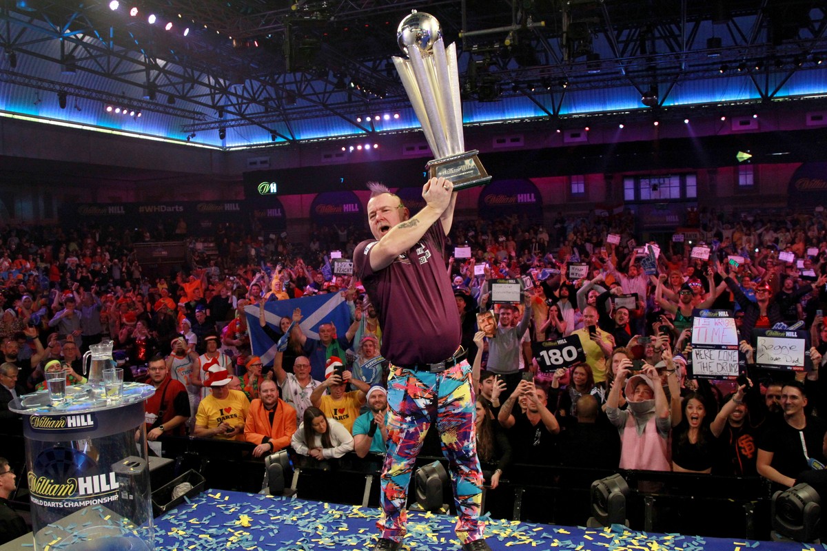 epa08098304 Scottish player Peter Wright poses with his trophy after winning the PDC World darts Final match against Michael van Gerwen at the Alexander Palace in North London, Britain, 01 January 202 ...