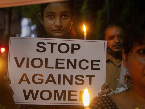 Indian women hold placards protesting against the alleged gang rape and killing of a Dalit woman in Uttar Pradesh state, in Gauhati, India, Saturday, Oct. 10, 2020. Protestors have been demanding the  ...