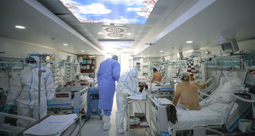 Medical staff attend to COVID-19 patients in a mobile ICU unit, set up on the hospital grounds to cope with the high numbers of seriously ill people at the Marius Nasta National Pneumology Institute i ...