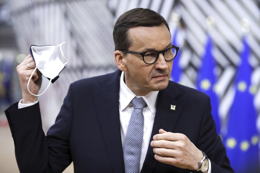 FILE - In this Monday, May 24, 2021 file photo, Poland's Prime Minister Mateusz Morawiecki speaks with the media as he arrives for an EU summit at the European Council building in Brussels. Democratic ...